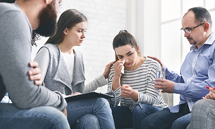 Understanding people calming crying woman during group session