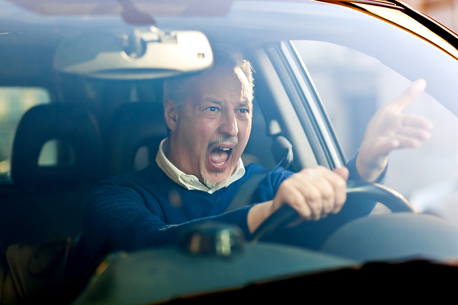 Angry man driving a car.