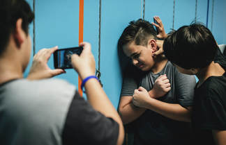 Young boy being bullied by other students