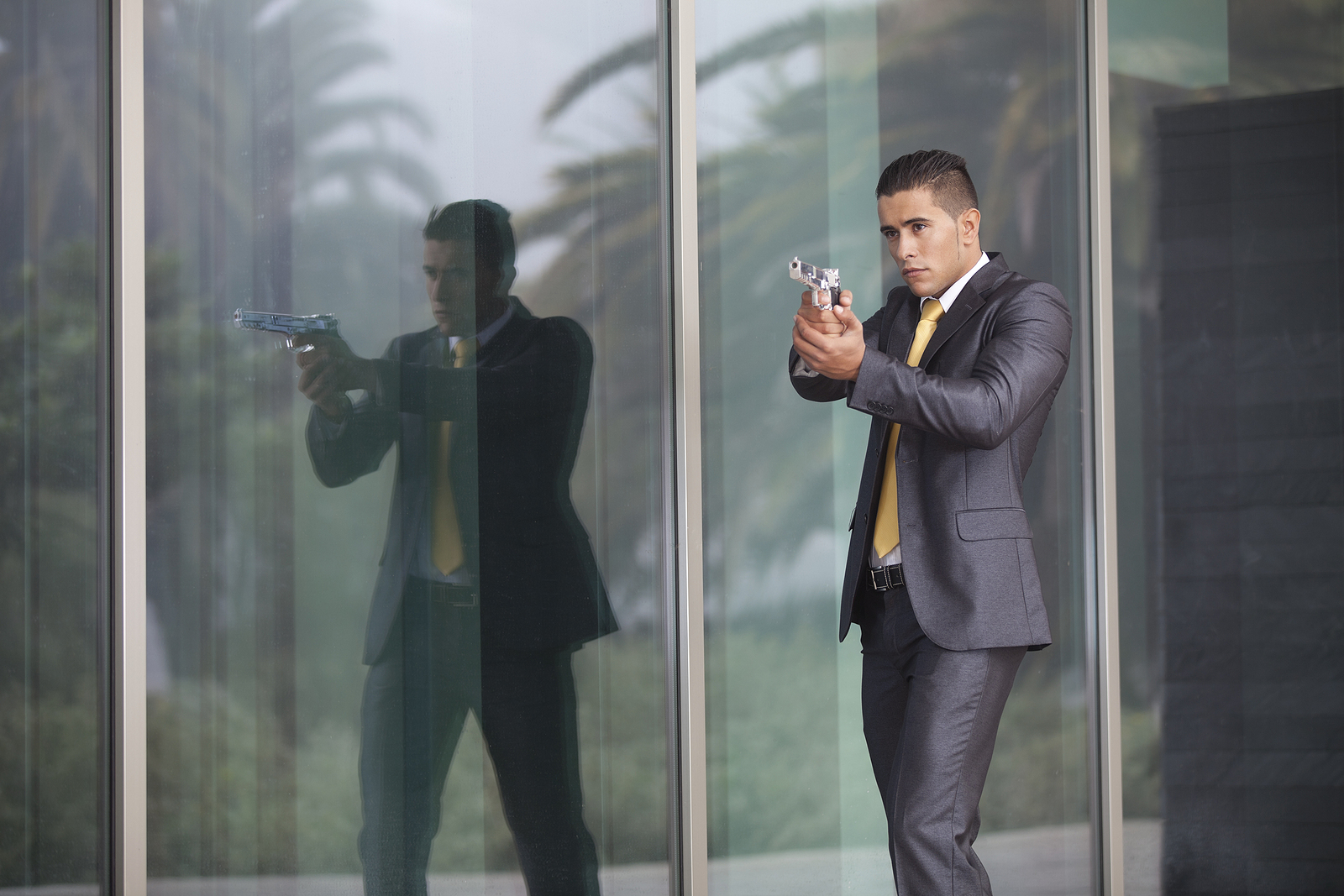 Powerful security businessman aiming a gun