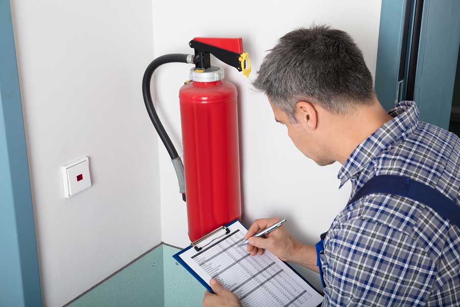 Man checking fire extinguisher