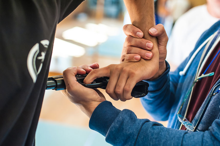 Hand holding another hand with gun