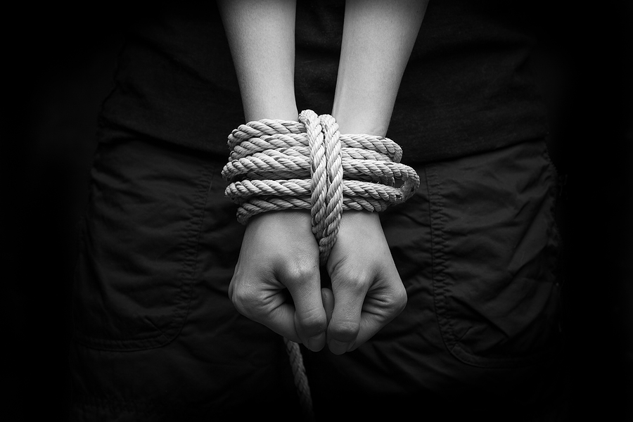 Hands tied up with rope