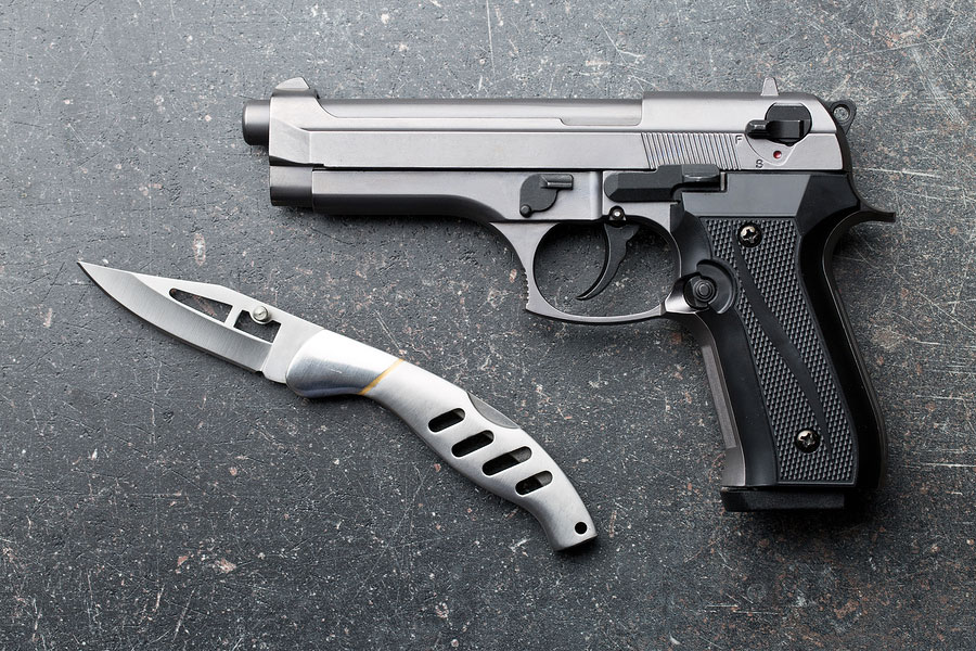 Handgun with pocket knife