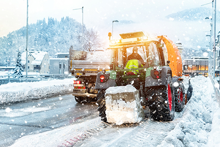 Snow plow plowing street