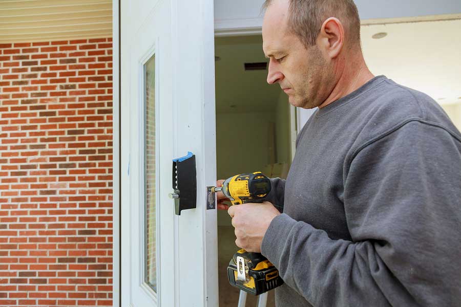 Man putting lock on a door