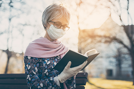 Senior Lady with Face Mask Reading the Bible