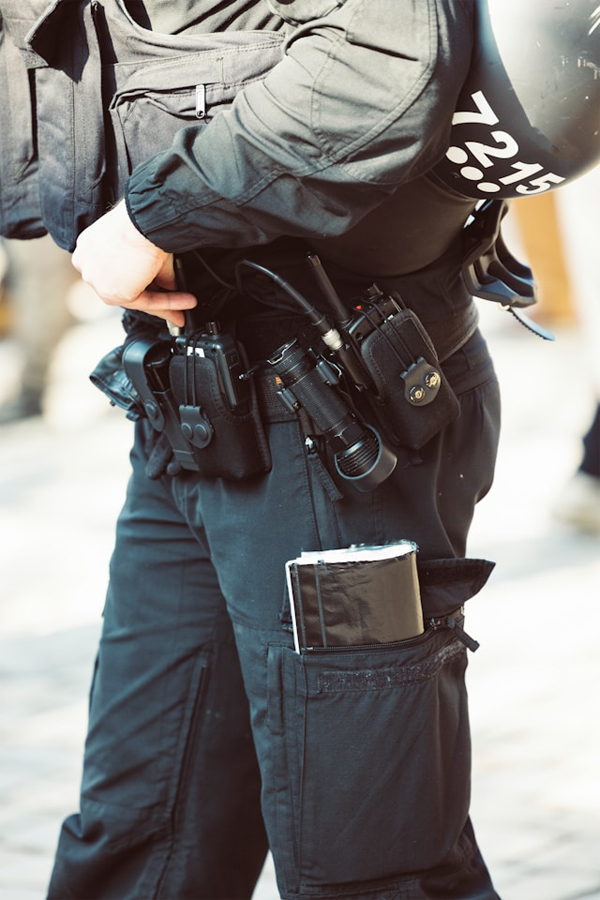 SWAT member wearing a belt with non-lethal weapons