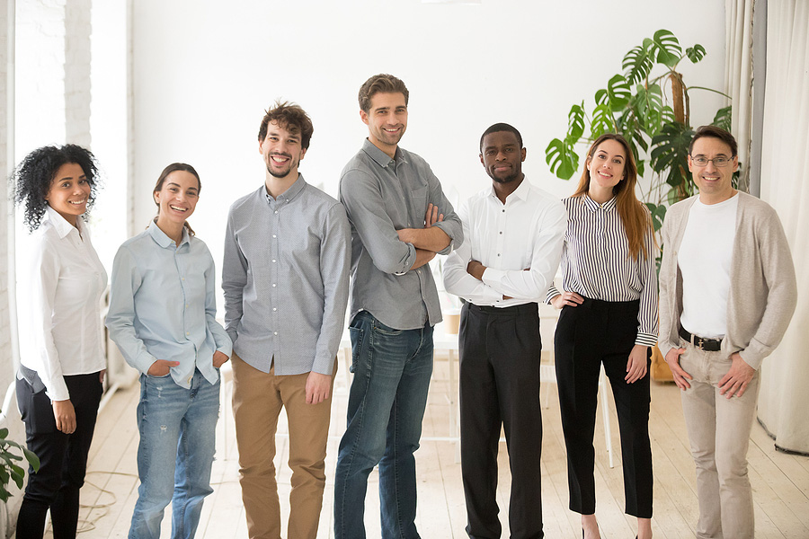 seven people of all races and genders standing together