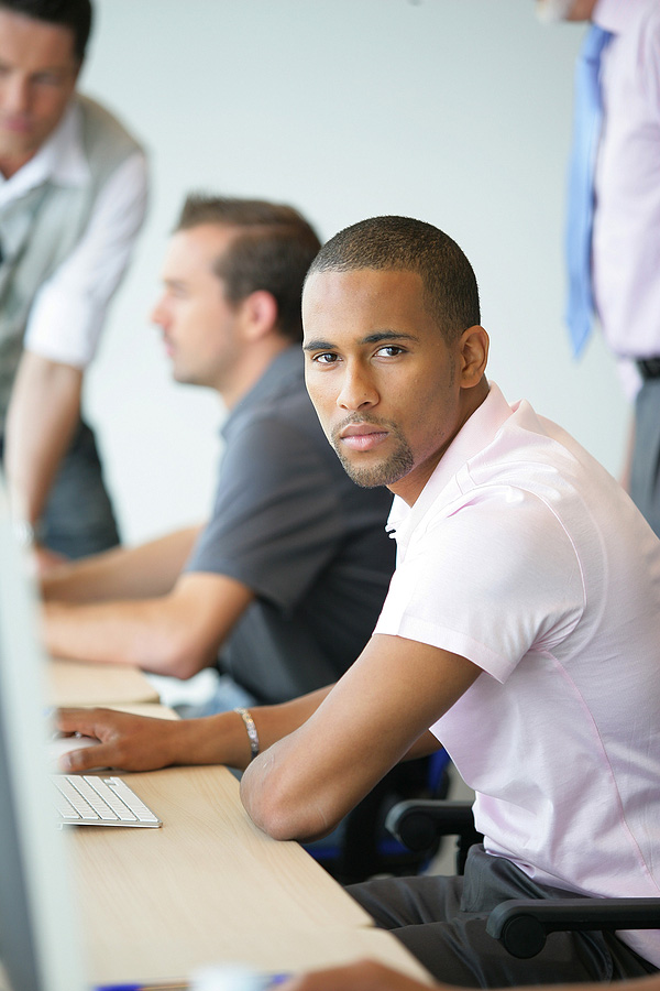 Portrait of a young man in front of a computer